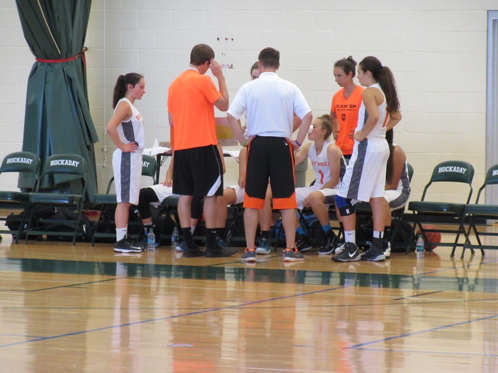The Bay Area girls' basketball team huddles during a timeout.