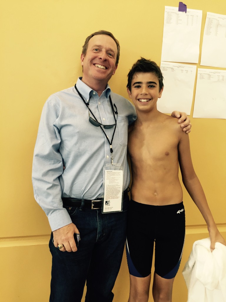 Ari and his dad between swimming events. He shattered his personal best in the 50 yard freestyle by 12 seconds! Wow!