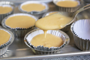 Pouring banana (nano) muffin batter into mini muffin tins