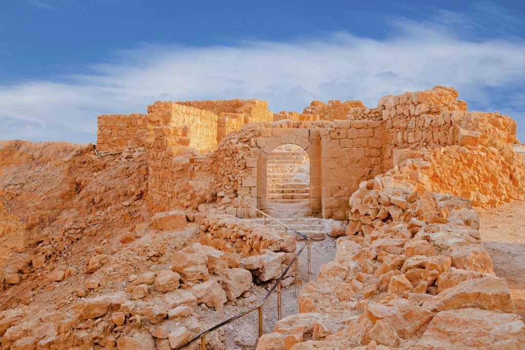 Ruins of Massada Fortress in Negev at sunset