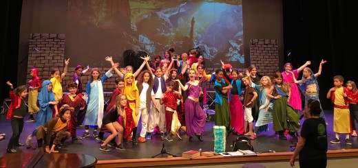 Yuval (sixth from left, in burgundy hat) was the youngest cast member in the OFJCC production of Disney's Aladdin JR.