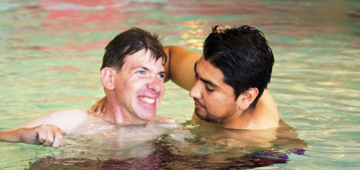 Abilities United participant John Pappas enjoys the OFJCC pool with assistance from Community Training Instructor Moises Acuña.